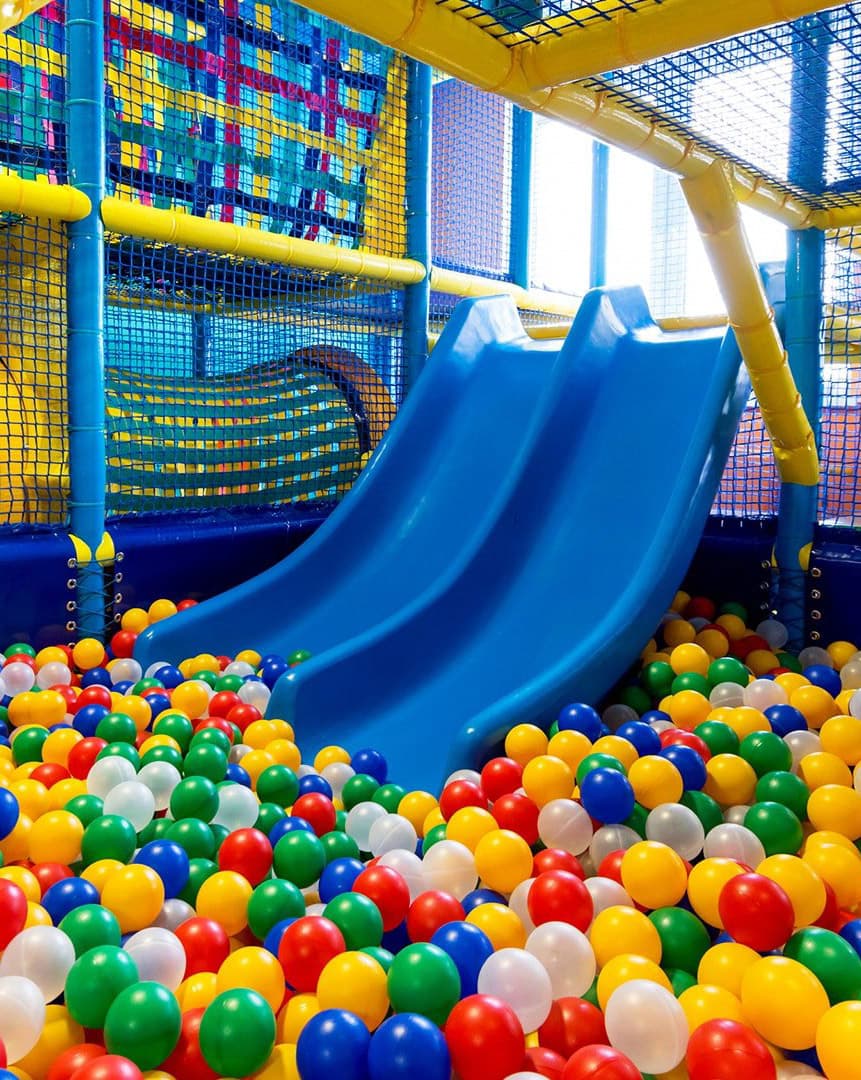 Blue slides running into the ball pit at the Kidsports indoor playground