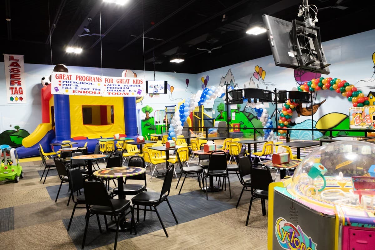 The main play area with the bouncy house, tables and arcade