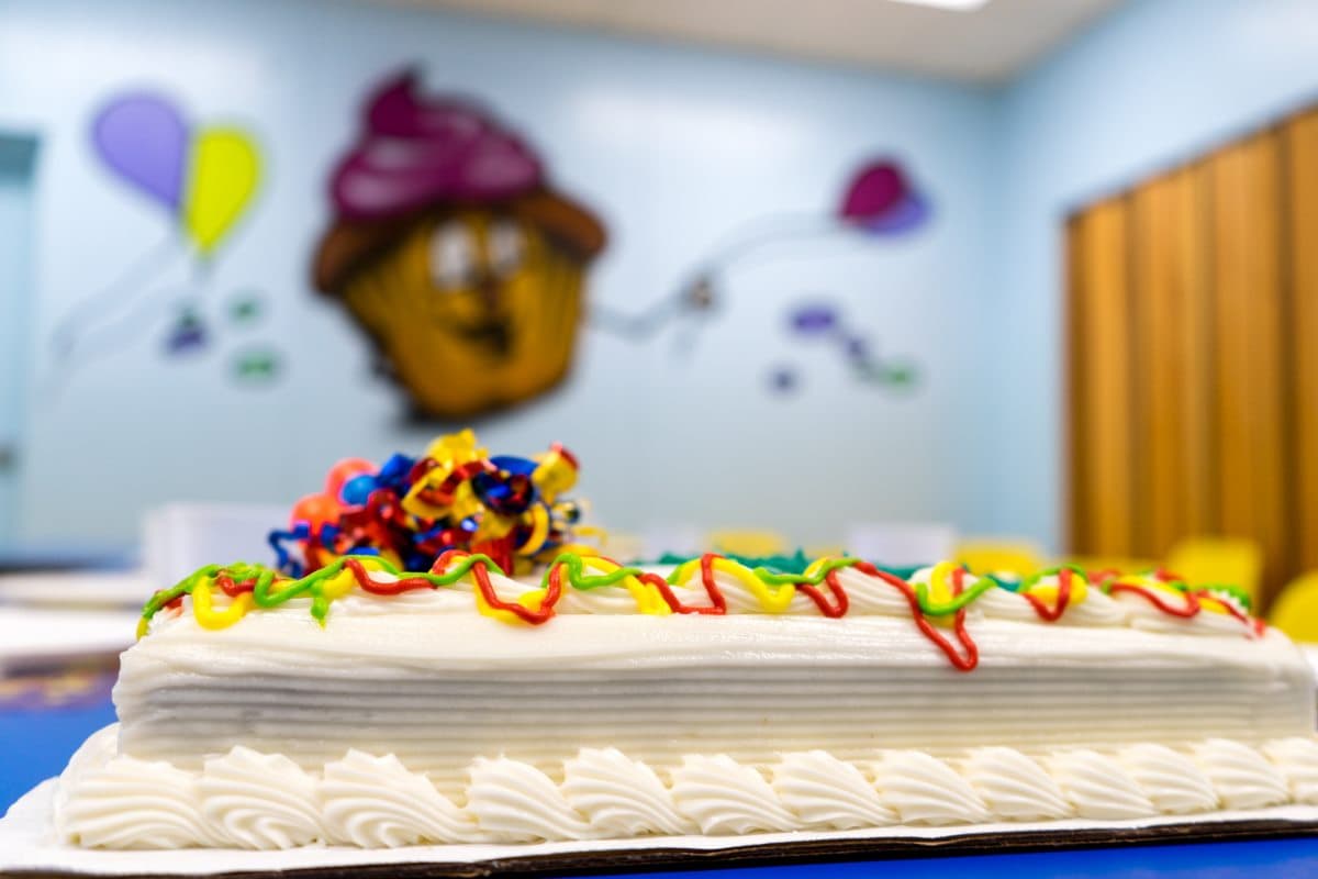 A birthday sheet cake with rainbow frosting