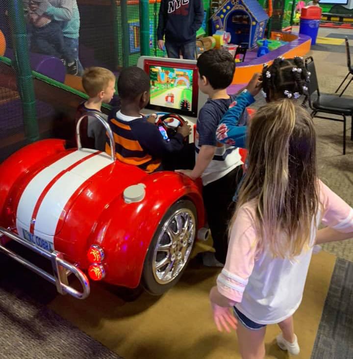 Kids racing in the red car arcade game